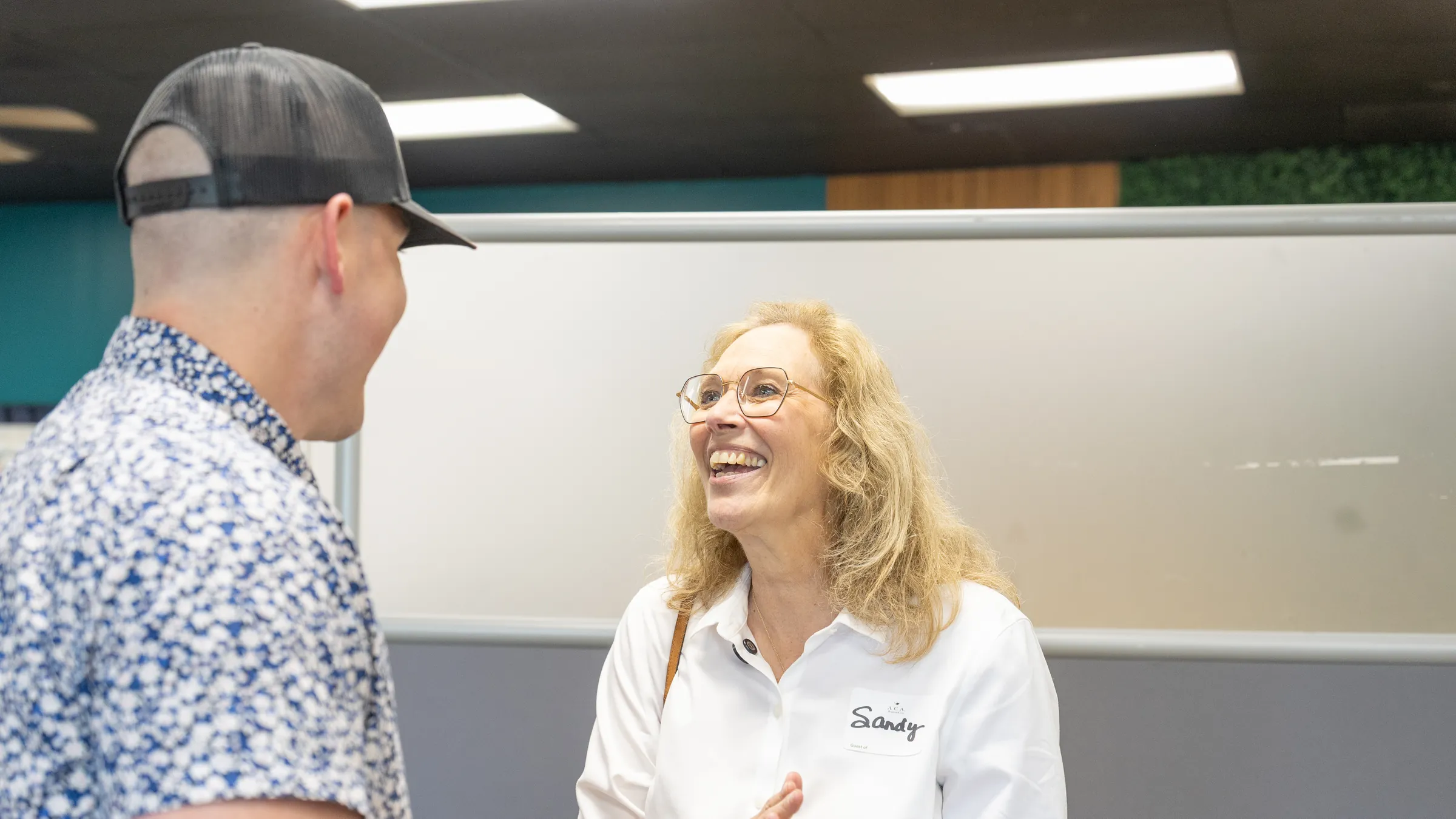 Aaron sharing a laugh with an attendee at a New Life event.